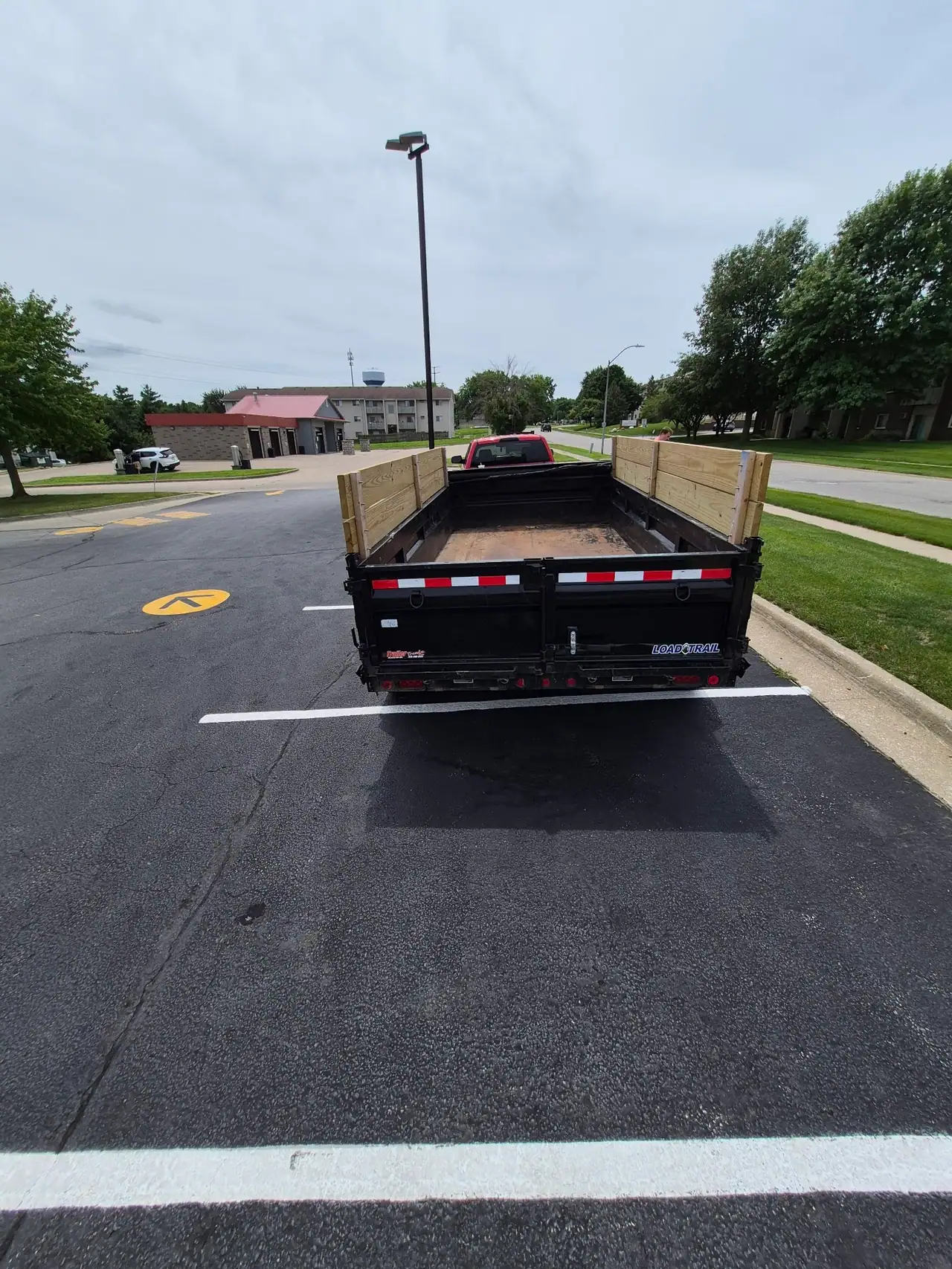 Empty dump trailer seen from behind, ready to be loaded